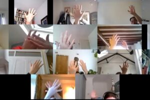 A picture of hands on a zoom team building online session